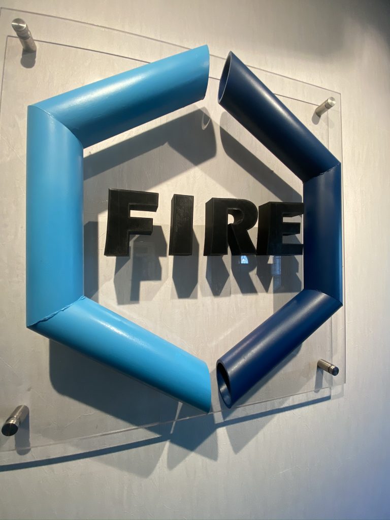 Fourte International Real Estate's FIRE logo displayed on a wall